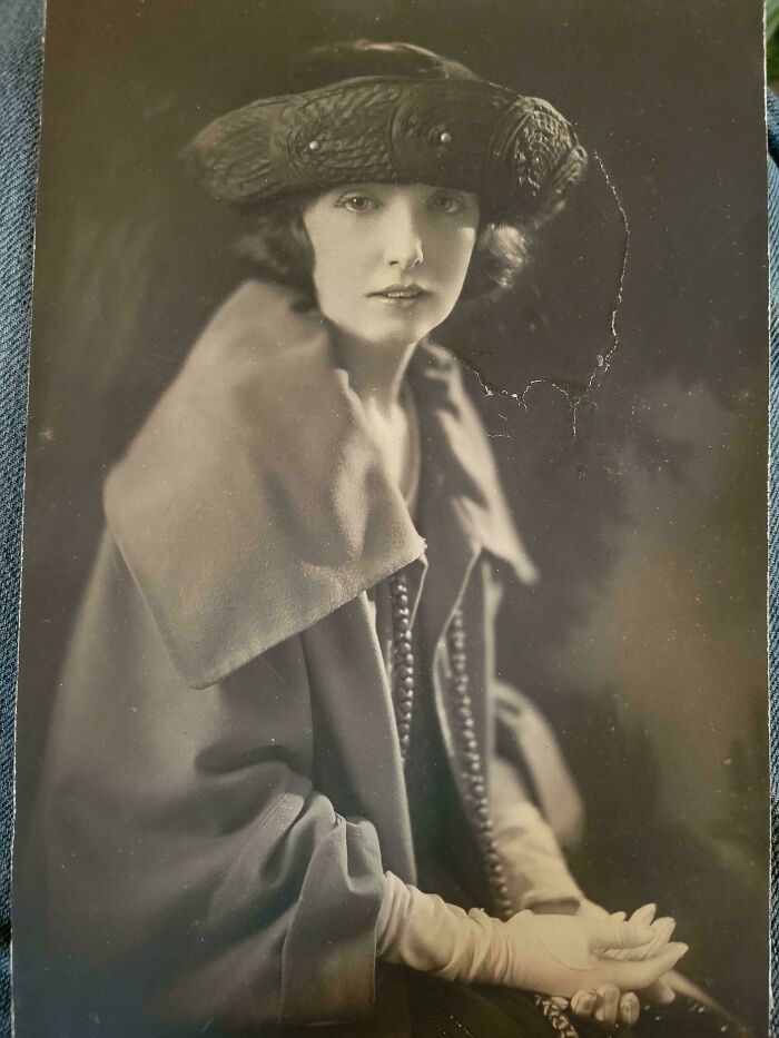 Vintage portrait of a woman in elegant attire and hat, showcasing old fashion styles not typically seen in history class.