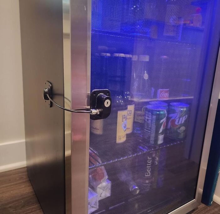 A secured fridge door with visible drinks, using innovative products for fridge organization.