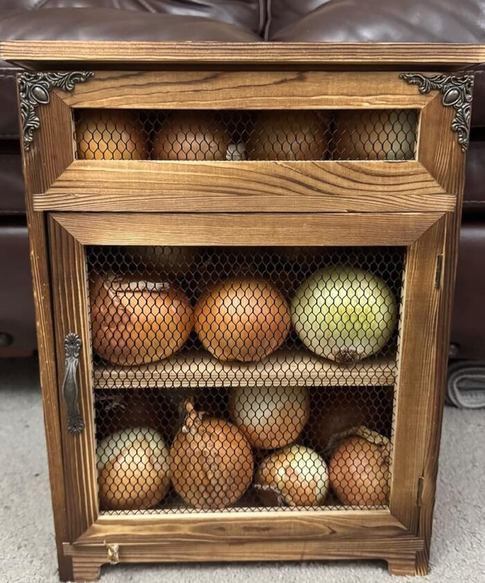 Wooden pantry storage with mesh doors holding onions, ideal for reinventing your fridge and pantry organization.