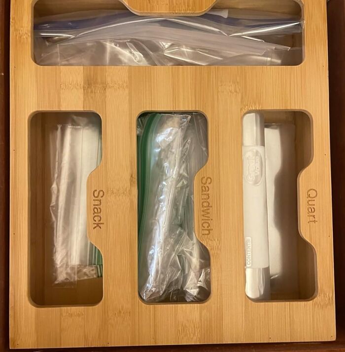 Bamboo organizer with sections for snack, sandwich, quart bags, optimizing fridge pantry storage.