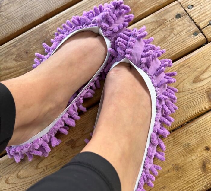 Purple mop slippers on wooden floor, a daily life saver tool.