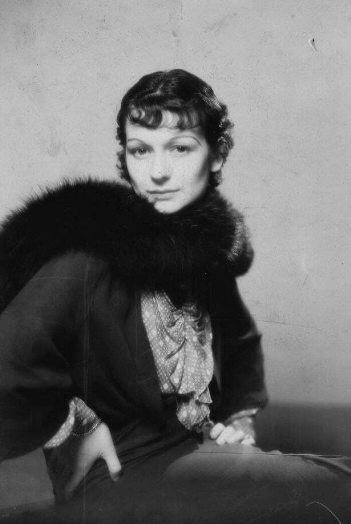 Vintage portrait of a woman in a fur collar, showcasing historical fashion elegance.