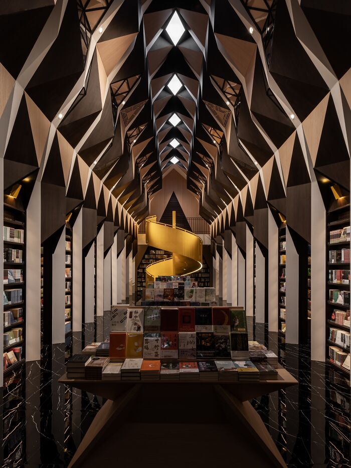 Innovative interior design with geometric ceiling and spiral staircase, showcasing modern aesthetics in award-winning space.