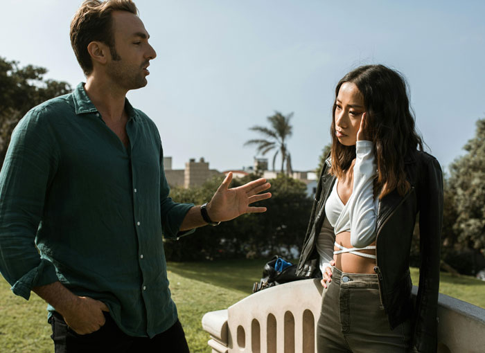 Young couple having a tense conversation in a park, relating to teenage relationship issues. Young couple having a tense conversation in a park, relating to teenage relationship issues.