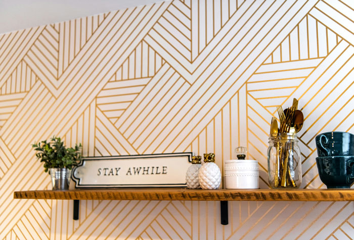Airbnb kitchen shelf with decor, plants, and utensils, promoting a welcoming stay. Airbnb kitchen shelf with decor, plants, and utensils, promoting a welcoming stay.