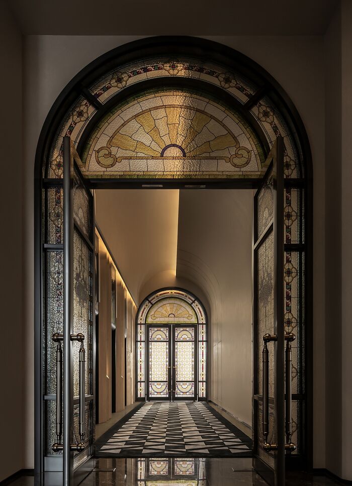 Elegant stained glass doors in a hallway, showcasing the excellence of interior design in award-winning architecture.