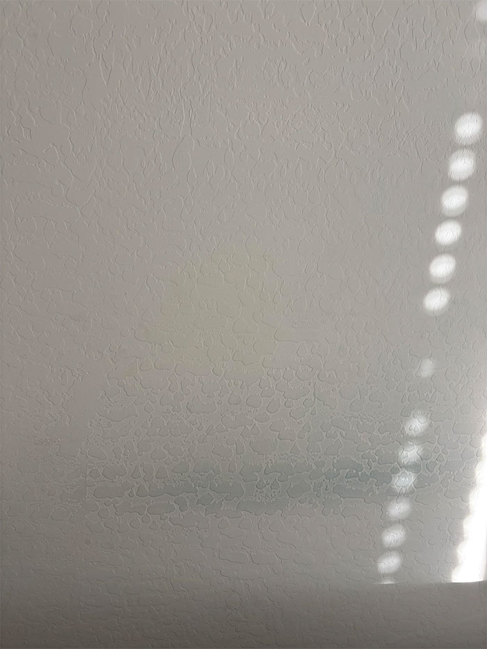 Wall with faint stains and dappled sunlight, related to online user comments about suspicions of a mistress's presence. Wall with faint stains and dappled sunlight, related to online user comments about suspicions of a mistress's presence.