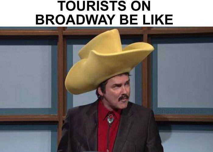 Man wearing an oversized yellow hat, captioned "Tourists on Broadway be like," humorous depiction of United States meme.