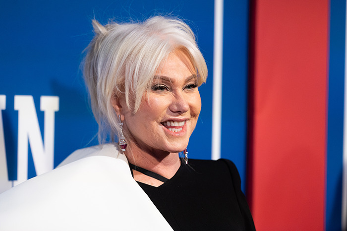 Deborra-Lee Furness with white hair at an event, wearing black clothing and earrings. Deborra-Lee Furness with white hair at an event, wearing black clothing and earrings.