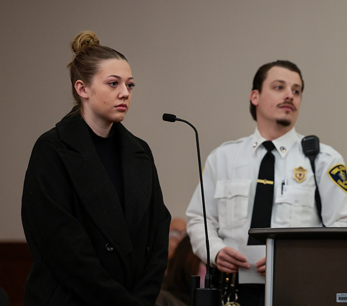 College student in courtroom with an officer, relating to a TikTok-inspired incident. College student in courtroom with an officer, relating to a TikTok-inspired incident.