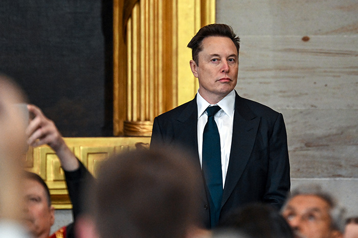 Elon Musk at a presidential inauguration, sparking memes with a mention of Mars, standing in a suit. Elon Musk at a presidential inauguration, sparking memes with a mention of Mars, standing in a suit.