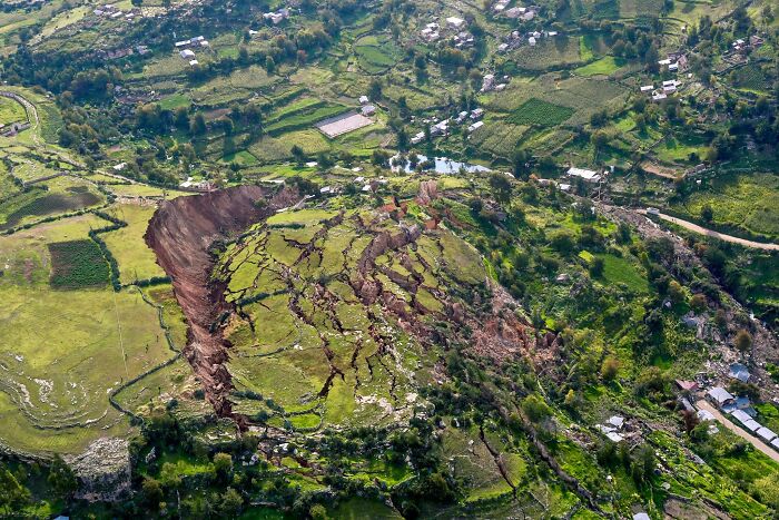 Aerial view of fascinating natural phenomena with a large landslide and c*****d earth in a rural landscape.