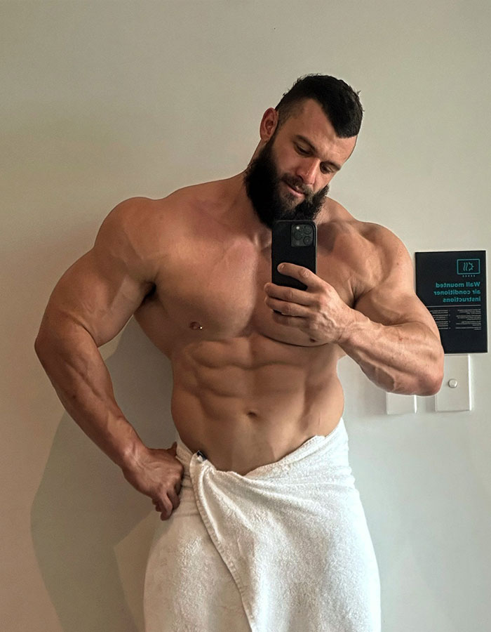 Muscular male stripper taking a selfie in a towel, illustrating bachelorette party experiences. Muscular male stripper taking a selfie in a towel, illustrating bachelorette party experiences.