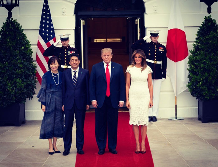 Freelance magician at White House event with officials on a red carpet, featuring military guards and national flags. Freelance magician at White House event with officials on a red carpet, featuring military guards and national flags.