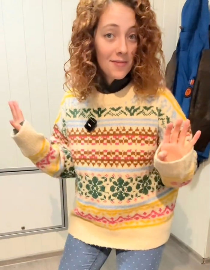Spanish nurse in a colorful Norwegian sweater, revealing a secret to staying warm, sparking a cold weather debate. Spanish nurse in a colorful Norwegian sweater, revealing a secret to staying warm, sparking a cold weather debate.
