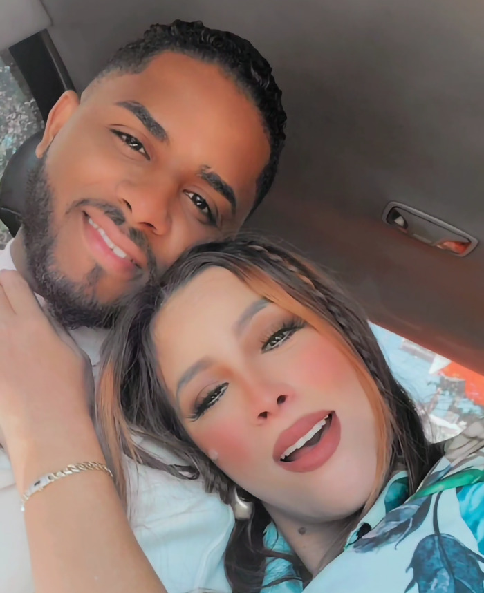 Couple smiling together in a car, facing the camera, capturing a happy moment. Couple smiling together in a car, facing the camera, capturing a happy moment.