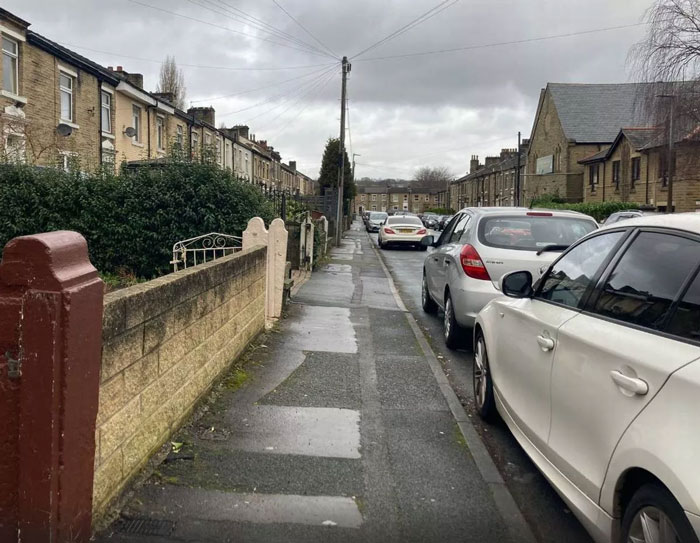 Residential street view with parked cars, cloudy sky, wet pavement; associated with arranged marriage bride case. Residential street view with parked cars, cloudy sky, wet pavement; associated with arranged marriage bride case.