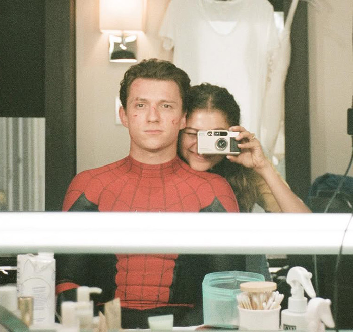 Zendaya and Tom Holland taking a playful mirror selfie, with Holland dressed as Spider-Man, capturing a romantic moment. Zendaya and Tom Holland taking a playful mirror selfie, with Holland dressed as Spider-Man, capturing a romantic moment.