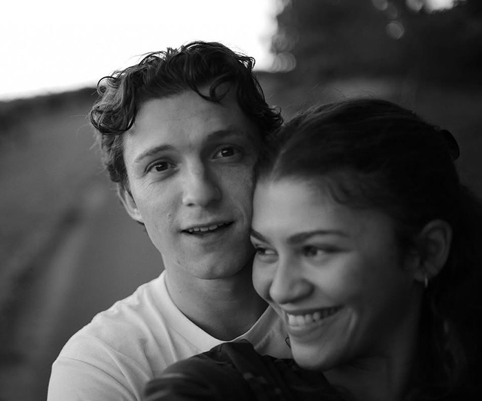 Zendaya and Tom Holland smiling together in an outdoor setting, highlighting a romantic and intimate moment. Zendaya and Tom Holland smiling together in an outdoor setting, highlighting a romantic and intimate moment.
