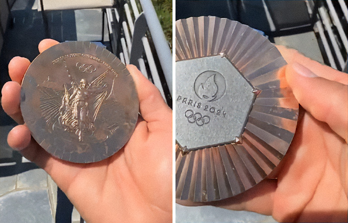 Close-up of hands holding a Paris 2024 Olympic medal, displaying both front and back engravings. Close-up of hands holding a Paris 2024 Olympic medal, displaying both front and back engravings.