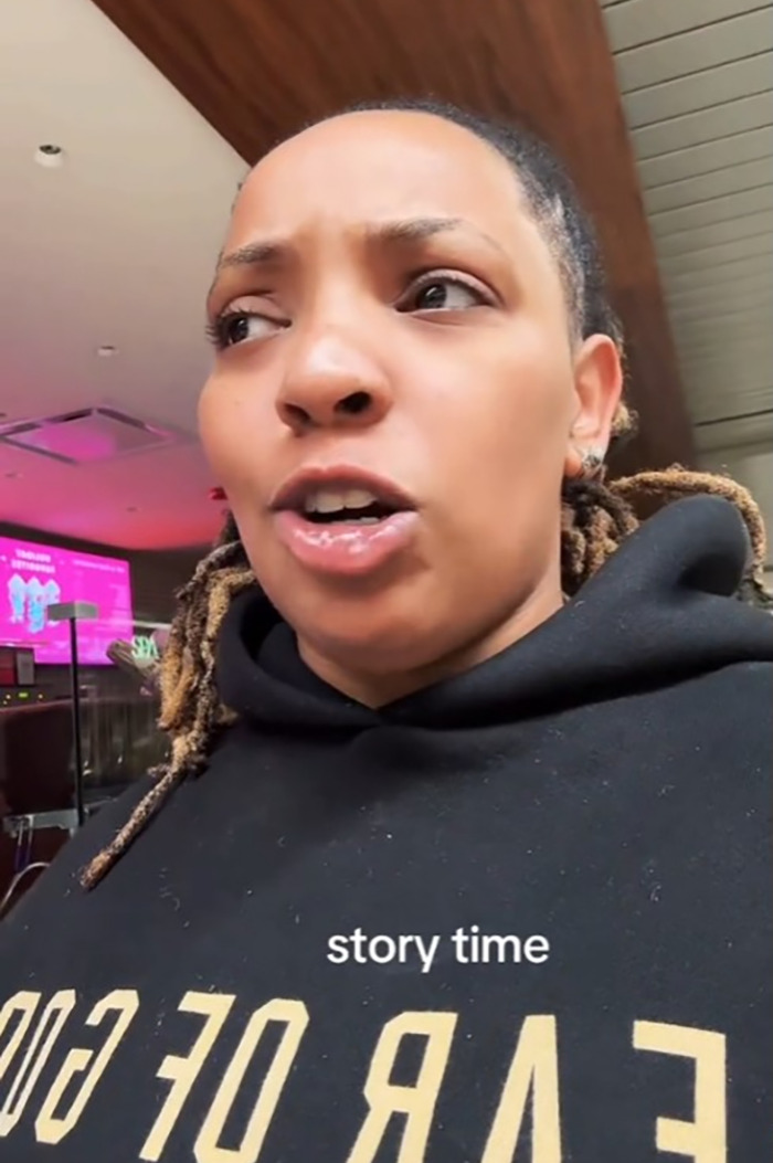 Black woman sharing experience about being removed from first class on a flight, with "story time" text on screen. Black woman sharing experience about being removed from first class on a flight, with "story time" text on screen.