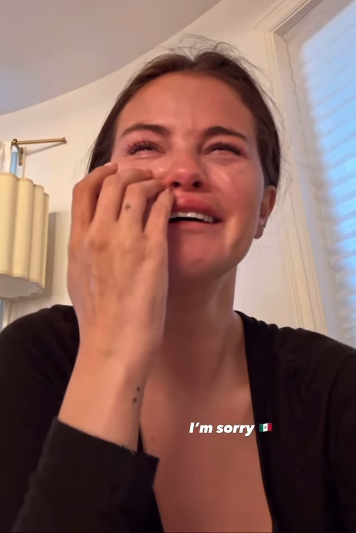 Selena Gomez crying while wiping tears. Selena Gomez crying while wiping tears.