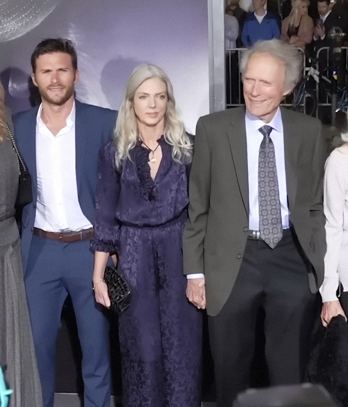 Father and son at an event, sharing an emotional moment after recent loss. Father and son at an event, sharing an emotional moment after recent loss.
