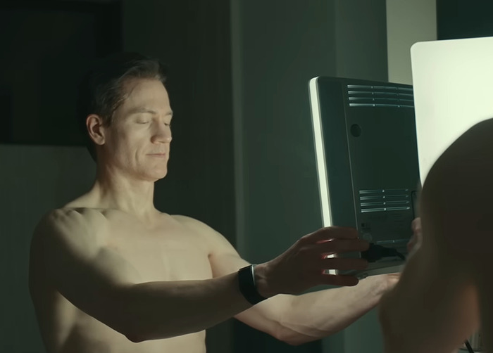 Bryan Johnson examining skin in the mirror, illustrating effects of longevity medication from Project Baby Face mogul. Bryan Johnson examining skin in the mirror, illustrating effects of longevity medication from Project Baby Face mogul.