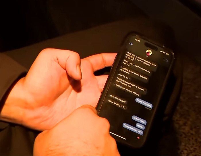 Hands holding a phone displaying a text conversation related to a plane crash. Hands holding a phone displaying a text conversation related to a plane crash.