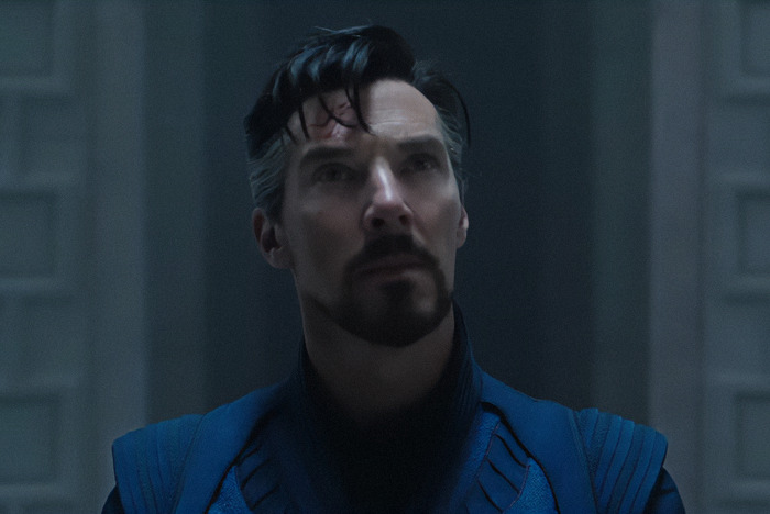 Benedict Cumberbatch in a contemplative pose, wearing a blue outfit in a dimly lit setting on a scene from 'Doctor Strange in the Multiverse of Madness.' Benedict Cumberbatch in a contemplative pose, wearing a blue outfit in a dimly lit setting on a scene from 'Doctor Strange in the Multiverse of Madness.'