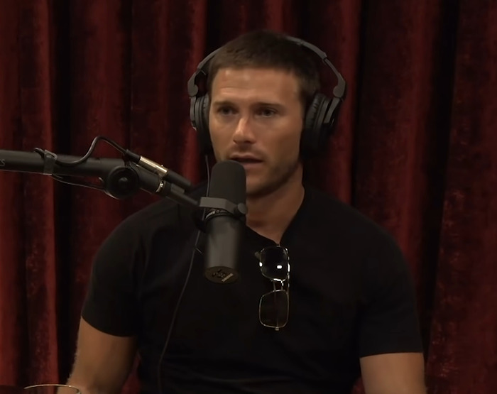 Clint Eastwood's son speaks into a microphone. Clint Eastwood's son speaks into a microphone.