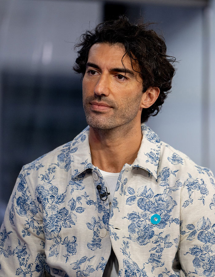 Man in a floral patterned shirt looking thoughtful; related to high-profile lawsuit. Man in a floral patterned shirt looking thoughtful; related to high-profile lawsuit.