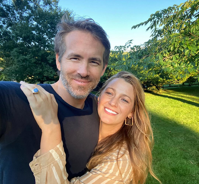 Blake Lively and husband Ryan Reynolds smiling for a picture outdoors. Blake Lively and husband Ryan Reynolds smiling for a picture outdoors.