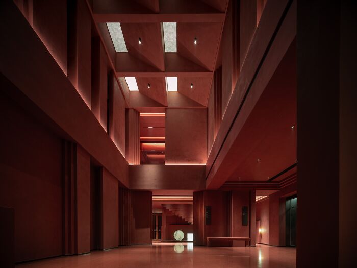 Award-winning interior design showcasing a modern architectural space with dramatic lighting and red hues.