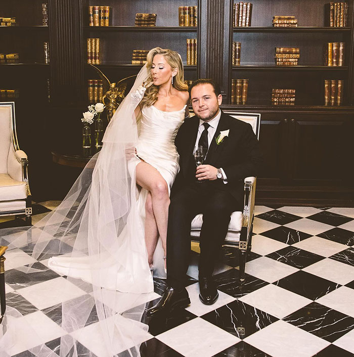 Bride and groom in elegant setting, with library bookshelves in background, celebrating their wedding day. Bride and groom in elegant setting, with library bookshelves in background, celebrating their wedding day.