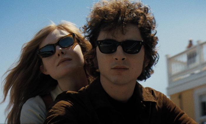 Two people wearing sunglasses, looking relaxed under a clear sky. Two people wearing sunglasses, looking relaxed under a clear sky.