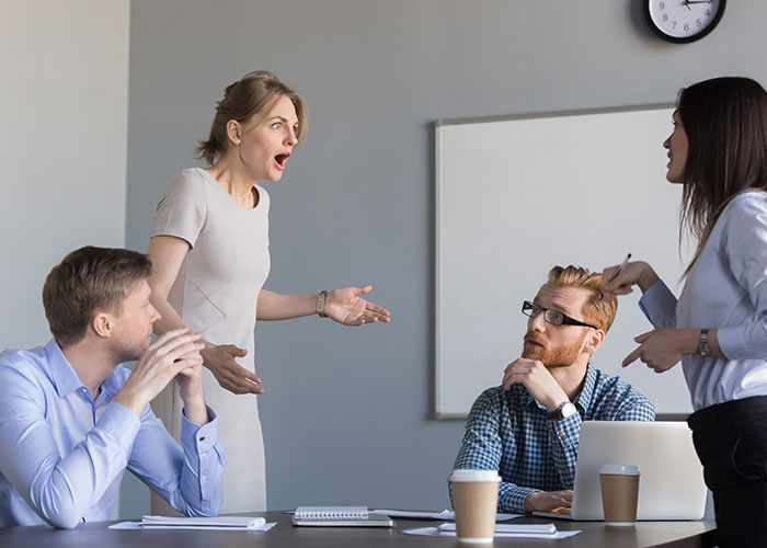 Office employees discussing at a potluck meeting, showing disappointment. Office employees discussing at a potluck meeting, showing disappointment.