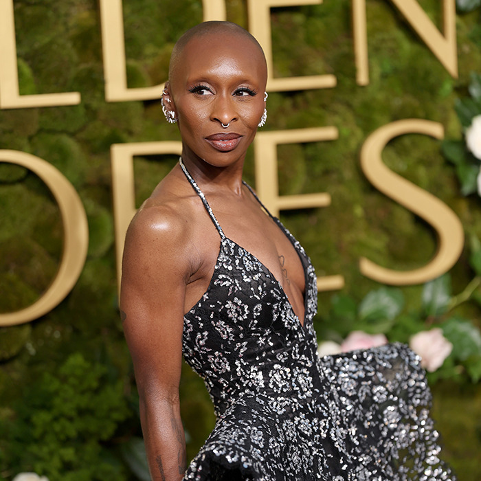 Cynthia Erivo in a floral gown at an event, sparking controversy over drama school treatment claims. Cynthia Erivo in a floral gown at an event, sparking controversy over drama school treatment claims.