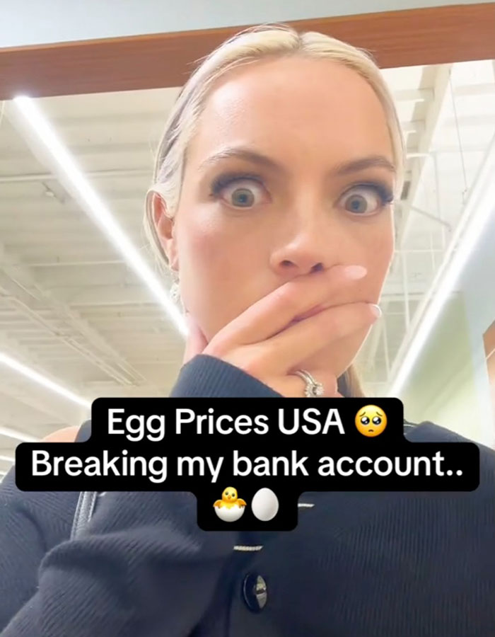 Woman surprised in grocery store with text commenting on high egg prices in the USA. Woman surprised in grocery store with text commenting on high egg prices in the USA.