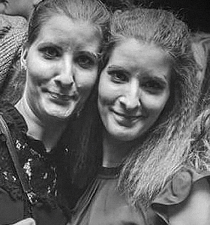Two women standing close together, smiling, black and white photo, missing sisters theme. Two women standing close together, smiling, black and white photo, missing sisters theme.