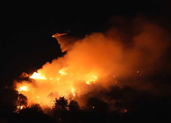 LA wildfires blaze intensely at night as smoke billows, highlighting environmental concerns in California. LA wildfires blaze intensely at night as smoke billows, highlighting environmental concerns in California.