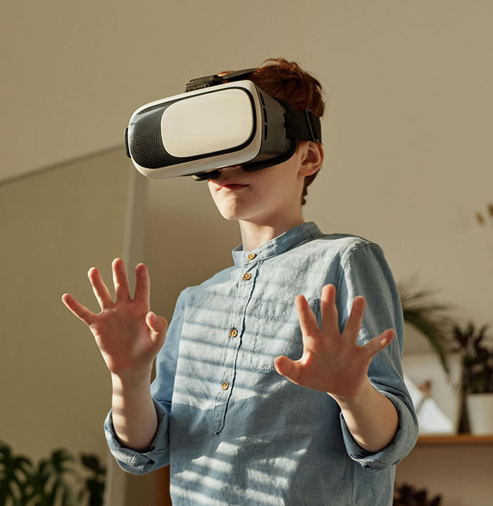 Young boy wearing VR headset, exploring virtual reality in a modern setting. Young boy wearing VR headset, exploring virtual reality in a modern setting.