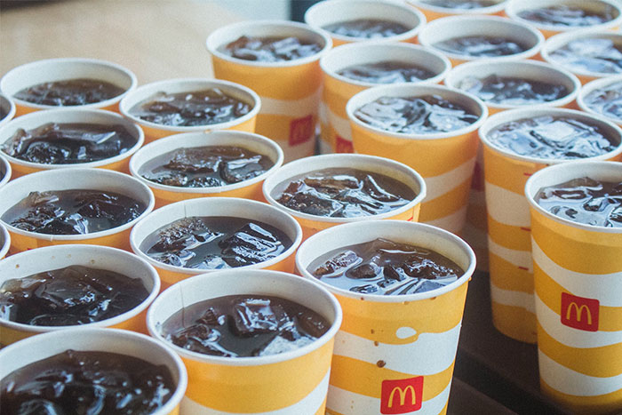 Numerous McDonald's soft drinks in paper cups, highlighting cultural insights from a German perspective. Numerous McDonald's soft drinks in paper cups, highlighting cultural insights from a German perspective.