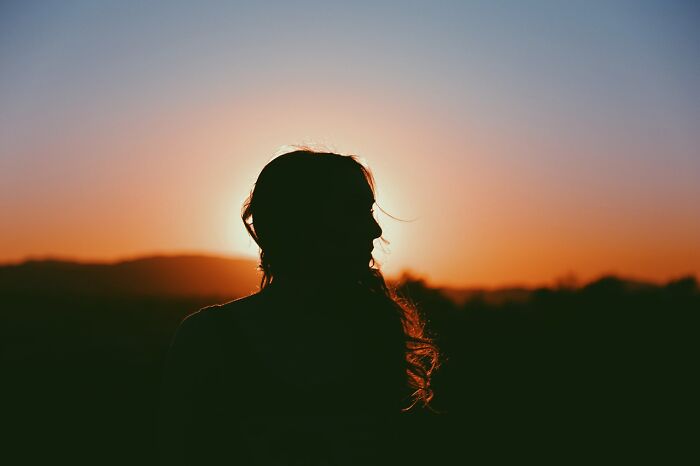 Silhouette of a person at sunset, concept of hidden celebrity profiles obscured by light. Silhouette of a person at sunset, concept of hidden celebrity profiles obscured by light.