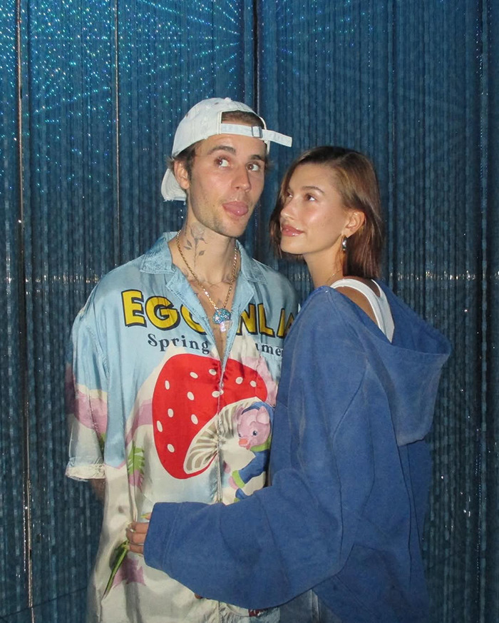Justin Bieber and Hailey Bieber posing together in casual clothing. Justin Bieber and Hailey Bieber posing together in casual clothing.