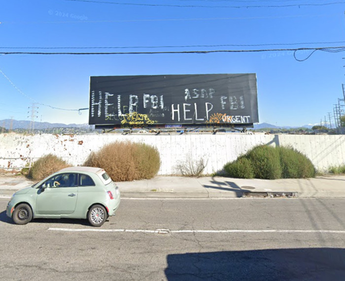 Billboard with "HELP" signs in graffiti, taken from Google Earth, sparking conspiracy theories. Billboard with "HELP" signs in graffiti, taken from Google Earth, sparking conspiracy theories.