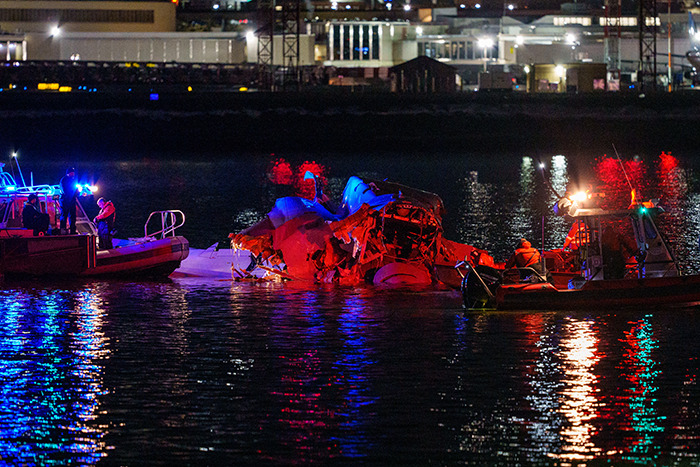 Rescue boats at night near wreckage of American Airlines plane crash in DC waters. Rescue boats at night near wreckage of American Airlines plane crash in DC waters.