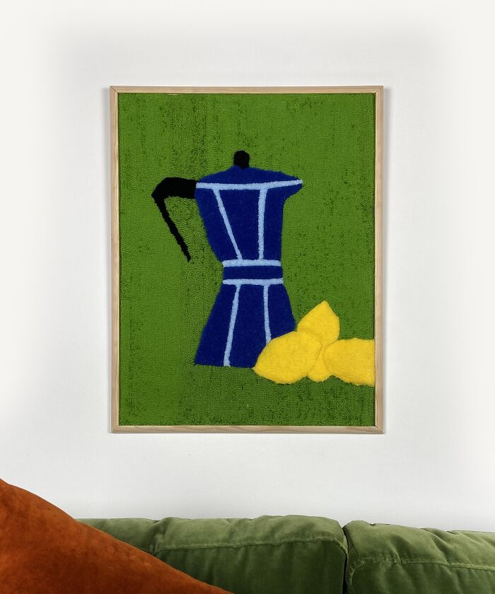 Tufted artwork by Cléa Delogu featuring a blue coffee pot and yellow lemons on a green background.