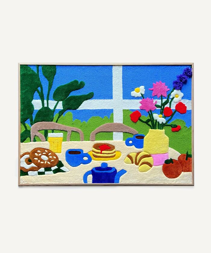 Tufted artwork by Cléa Delogu featuring a colorful breakfast scene with pastries, tea, and flowers by a window.