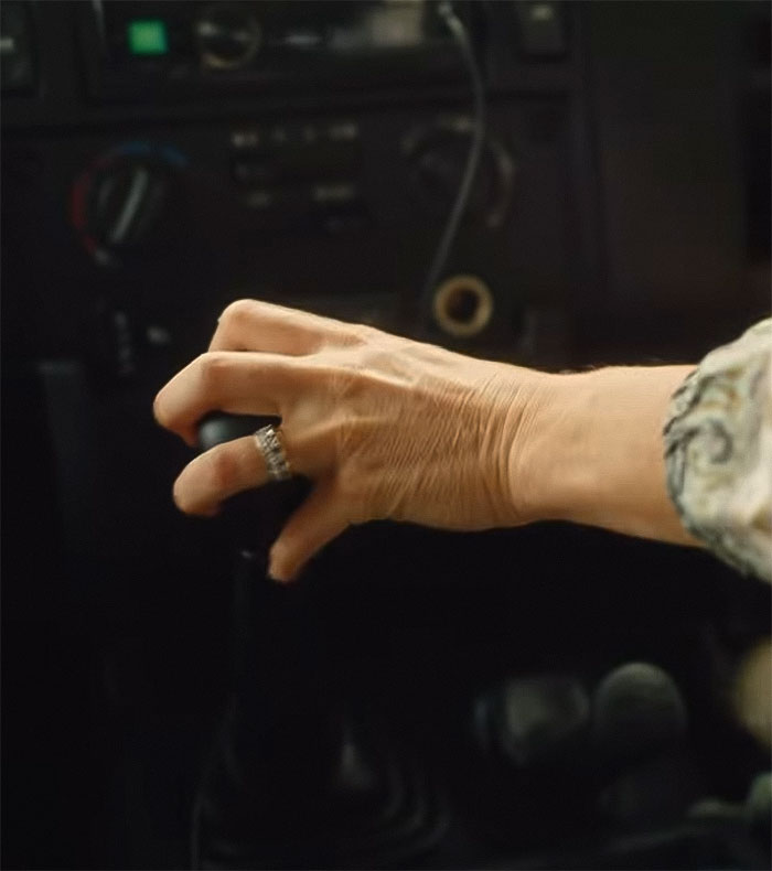 Close-up of a hand with an engagement ring on the steering wheel, sparking theories about its mystery. Close-up of a hand with an engagement ring on the steering wheel, sparking theories about its mystery.